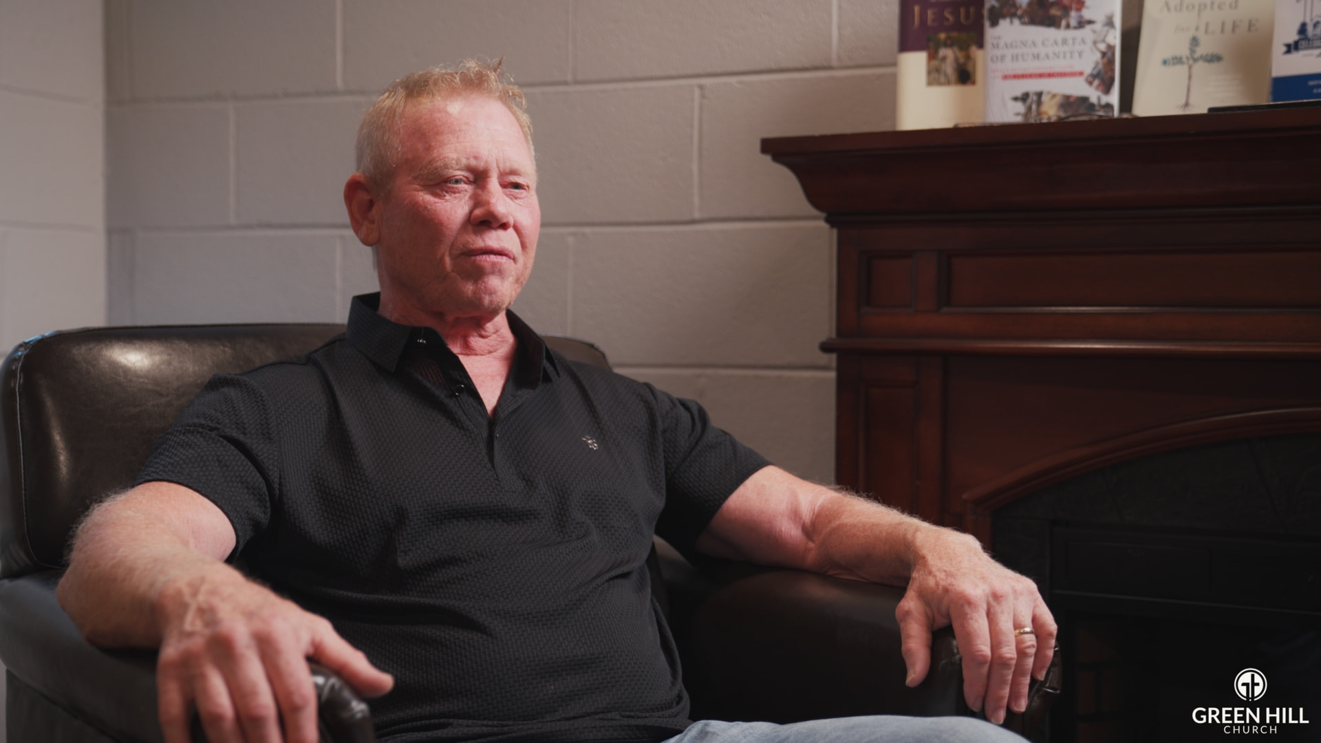 Interview subject beside fireplace